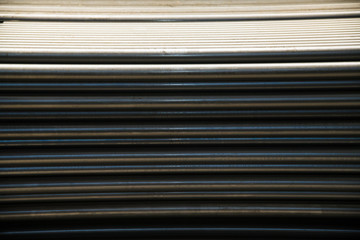 Fototapeta premium Plant for the production of metal pipes. Stack of steel pipes