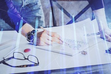 Financial trading chart double exposure with man desktop background.