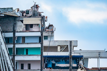 Picture of destruction. A dilapidated house without an external wall. Rooms in a ruined house....