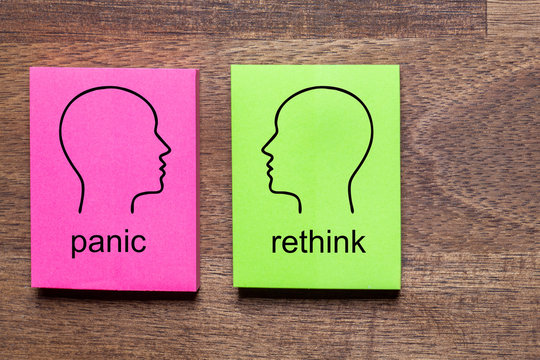panic and contradicted rethink is written on purple and green notes stickers, each with a mirrored outline of a head in black