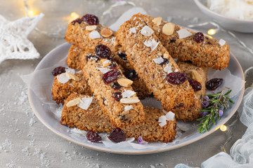 Granola bar. Healthy snack. Cereal granola bar with nuts, fruit, coconut and cranberries on a christmas table
