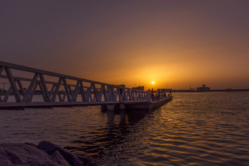 Evening scene of a seaside pier bridge of Muscat, Oman during sunset or dawn. 