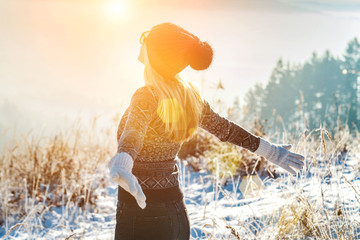 Happy female traveler resting on top of mountain under blue sky