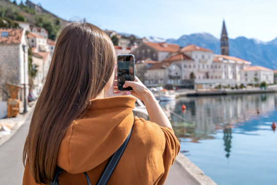 Young Girl Taking Photos Of Landscape With Mobile Smart Phone