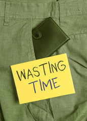 Writing note showing Wasting Time. Business concept for act of spending time doing something that...