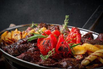 Mixed roast beef steaks set on a plate of tenderloin and Striploin. Barbecue menu for the restaurant