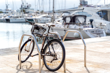Fototapeta na wymiar Bicycle parked in the port of Montenegro on the background of yachts