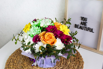 Bouquet of beautiful flowers and letter board with text. 