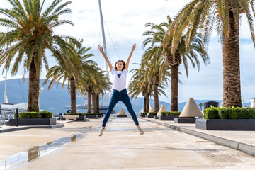 happy woman jump as a simbol of freedom at sea in Montenegro