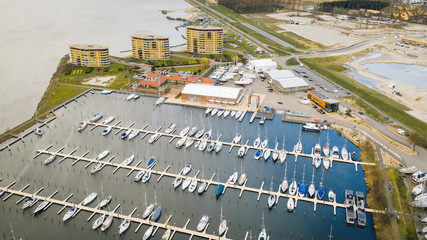 harbour in the winter with sailing boats and yachts shot from above in the netherlands, holland, flevoland, almere, amsterdam