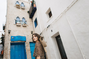 young tourist woman in the streets of the old town of Peniscola, Spain