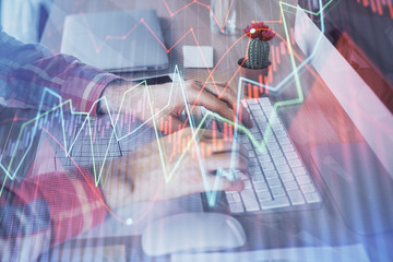 Double exposure of stock market chart with man working on computer on background. Concept of...