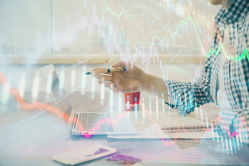 Multi exposure of stock market chart with man working on computer on background. Concept of financial analysis.