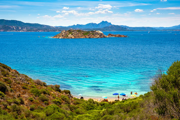 Caprera Island and Spiaggia di Cala Portese harbor at the Tyrrhenian Sea coastline with Isola Porco island, La Maddalena archipelago and the Sardinian mainland in background in Sardinia, Italy