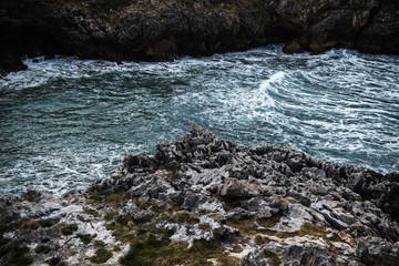 Waves breaking on the shore cliffs relaxing deep