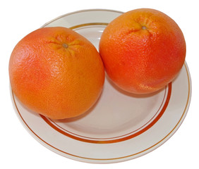 Group of two whole fresh pink grapefruit on plate