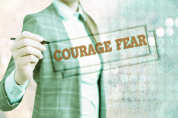Conceptual hand writing showing Courage Fear. Concept meaning quality of mind that enables a...