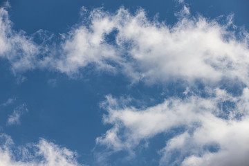 Light fluffy white clouds on a blue sky