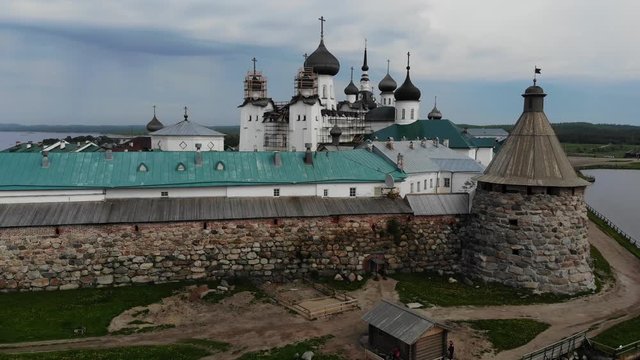 A slow flight near the walls and towers of the Solovetsky Kremlin on a cloudy day with soft lighting. This is part of the fortress of the Solovetsky monastery (1420)