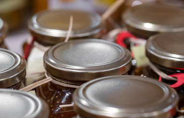 Fresh strawberries homemade jam in jars for sale at the farmers market
