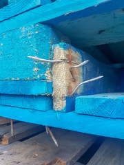 detail of a broken wooden pallet with nails out