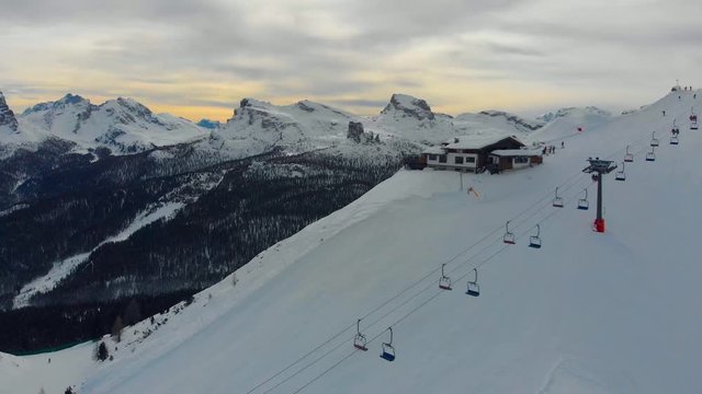 Aerial shot of ski lodge and chairlift in sunset in beautiful ski center in Italy, Dolomites
