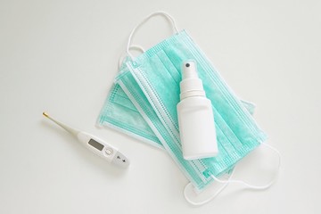 Coronavirus prevention, protective medical mask, disinfection spray, thermometer, protection measures.