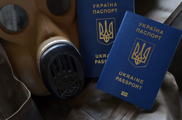 Concept. Ukrainian passport and gas mask. Ukrainian health collapse and corruption threaten Europe in pandemic COVID19 virus
