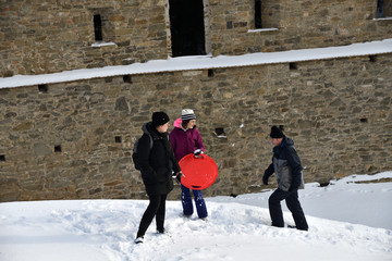Tourist hiking in the ruins castle on the snow in Slovakia Zborov ruins