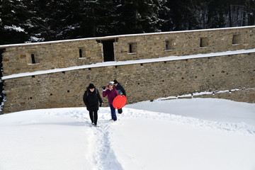 Tourist hiking in the ruins castle on the snow in Slovakia Zborov ruins