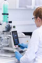 Chemist extracting cbd with rotavapor in laboratory