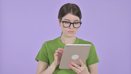The Attractive Young Woman using Tablet on Purple Background