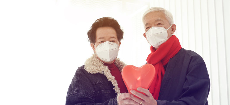 Asian elder senior couple encourage and support to win fight Coronavirus while wearing mask protection