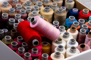 Professional tailor sewing Thread spools in different colors