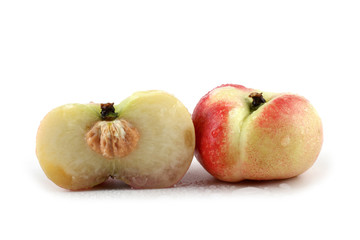 Donut peach (UFO peach) with a half