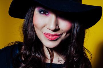 girl in the hat posing in the Studio