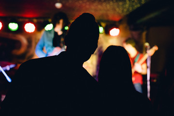 Two people (couple) on a concert in a night club party to music