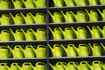 Rows of green watering cans for decoration