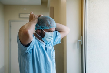 Staff putting on mask in hospital