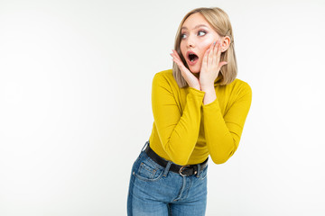 surprised girl in a lemon turtleneck and jeans posing on an isolated white background with copy space