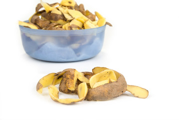 Potato peels in a bowl on a white background