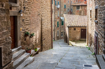 View with narrow picturesque medieval street of Tuscany old town Cortona, Italy
