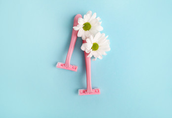 Pink razor on a blue background. Hair removal concept