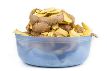 Potato peels in a bowl on a white background