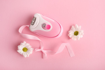 Pink razor with flowers on a pink background. Hair removal concept.