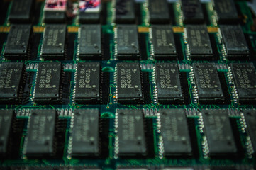 Green electric circuit board with microchips, close up.