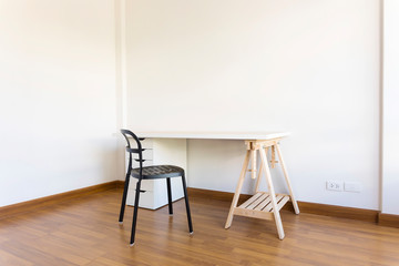 working space with wood table and chair in white empty room. Interior space.