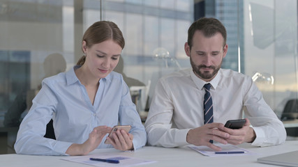 The Business people using Smartphone on Office Table