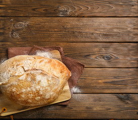 Fresh baked bread on  wooden background