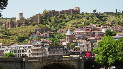 Fototapeta na wymiar View towards Metekhi Bridge and the Old Town district of Tbilisi, the capital city of Georgia in Eastern Europe. Georgia, Tbilisi - June 2019